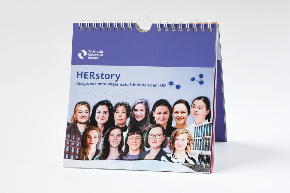 Stehender Kalender mit Brailleschrift, Vorderseite "HERstory - Ausgezeichnete Wissenschaftlerinnen der Technischen Universität Dresden", Foto mit Köpfen der Wissenschaftlerinnen