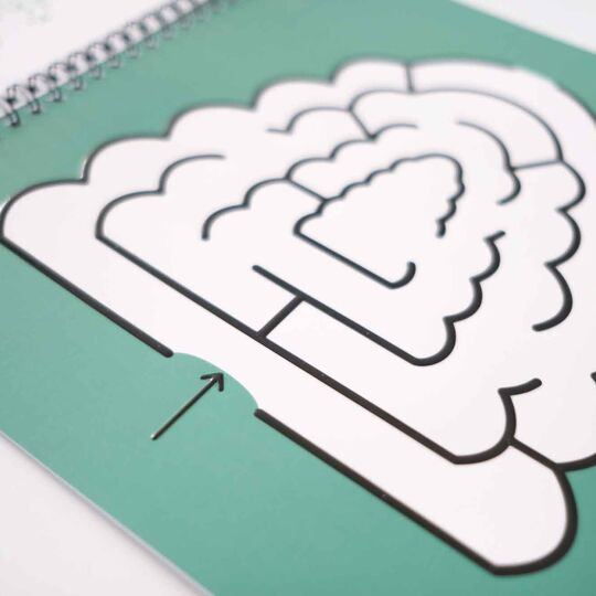 Aufgeschlagenes Ringheft mit einem Baum als Labyrinth